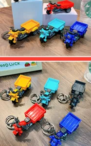 Close-up detail of colorful mini tricycle model keychains in red, blue, yellow and black