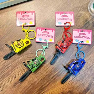 Mini pull-string vibrating chainsaw keychain toy in four bright colors for backpack charm