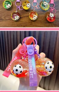Close-up of a soccer keychain featuring a clear liquid-filled ball and colorful strap.