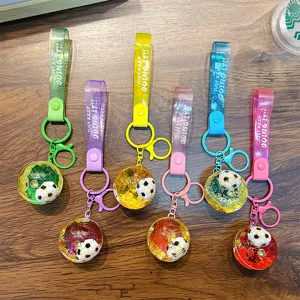 Set of 6 colorful floating soccer ball keychains with liquid glitter and "JUST KEEP DOING IT" straps.