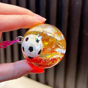Liquid quicksand football keychain with sparkling glitter and stars for bag charm