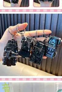 Detailed view of four black armored police vehicle model keychains with rotating turrets