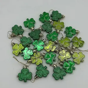 Detailed view of green shamrock hanging ornaments for St. Patrick's Day party decor.