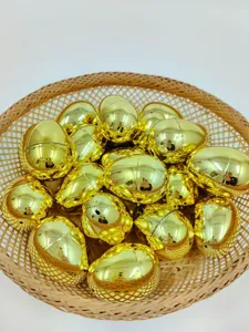 Detailed view of 4cm openable golden metallic plastic Easter eggs in a woven basket