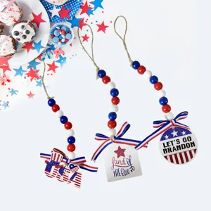 Close-up of patriotic wooden bead pendants with USA and Let's Go Brandon themes.