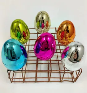 Set of six small 4cm shiny metallic electroplated plastic Easter eggs on a brown wire rack.