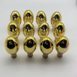 Detailed view of multiple golden electroplated plastic Easter eggs on wooden stands