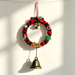 Handmade red and green pipe cleaner Christmas wreath with a golden bell pendant decoration.