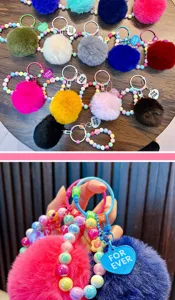 Detail of cute colorful beaded pom-pom keychain with heart-shaped charm and metal ring