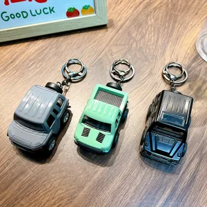 Miniature alloy off-road vehicle model keychains in grey, mint green, and black finishes