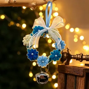 Close-up of DIY blue and white chenille stem Christmas wreath with silver bell ornament