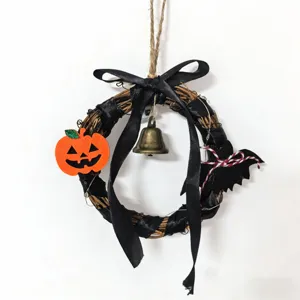 Handcrafted Halloween vine wreath hanging decoration with pumpkin bell and black ribbon