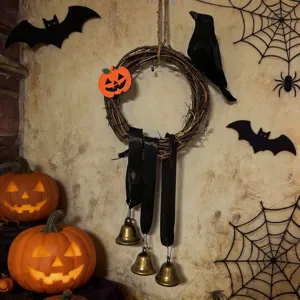 Rustic Halloween vine wreath featuring black ribbons and vintage brass bells decoration