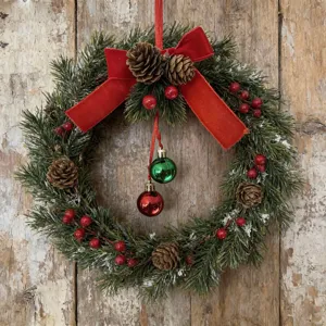 Rustic Christmas wreath featuring red velvet bow, natural pinecones and shiny ornaments