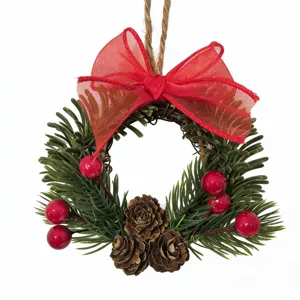 Festive Christmas wreath with large red bow berries and pine cones on white background