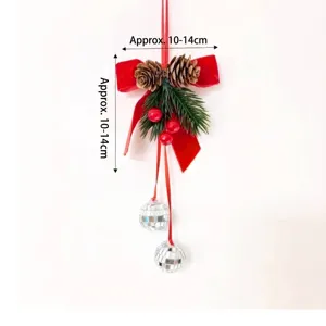 Red velvet bow Christmas hanging ornament with pine cones and silver disco balls.