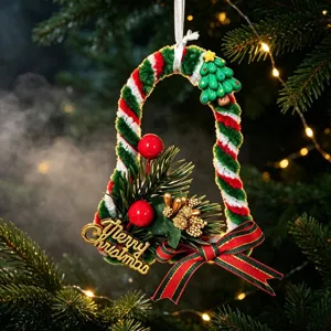 Close-up of handmade pipe cleaner Christmas bell ornament with Merry Christmas sign