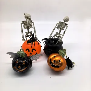 Detail view of Halloween decor set with skeletons, spiders, and metallic pumpkin pendants