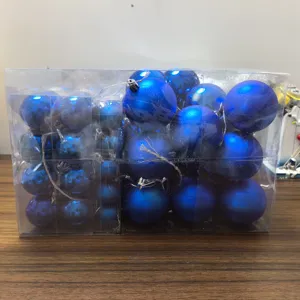 Close-up of assorted blue Christmas baubles packed in a clear rectangular gift box