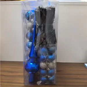 Christmas decoration set with blue ornaments and LED string lights in a clear gift box.