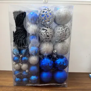 Close-up of a festive Christmas gift box containing blue and silver decorative balls and LED lights