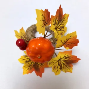 Macro view of a Thanksgiving napkin ring featuring a decorative pumpkin and maple leaves