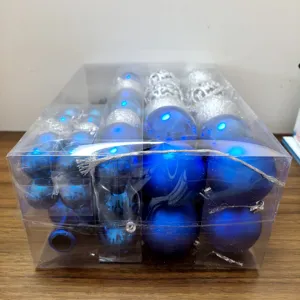 Set of blue and silver Christmas ball ornaments in a clear gift box for tree decor
