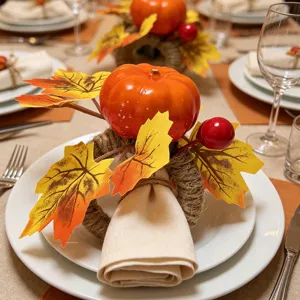 Detail view of a Thanksgiving napkin ring with a faux pumpkin and yellow maple leaves.