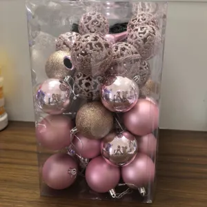 Boxed set of pink Christmas ornaments featuring matte, glitter, and hollow designs