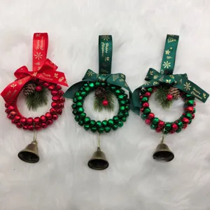 Detailed view of three handmade Christmas jingle bell wreaths with pinecones and ribbons.