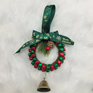 Detailed view of a festive red and green bell wreath with Happy Christmas ribbon