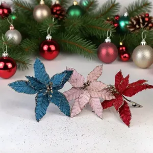 Three glittery artificial poinsettia flowers in blue pink and red for Xmas tree decoration