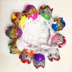 Macro view of 10 colorful DIY sequined plastic Easter eggs with elegant ribbon bows