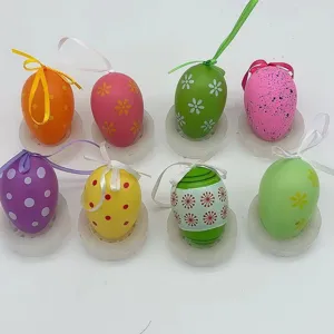 Detailed view of eight colorful patterned plastic Easter eggs with hanging ribbons