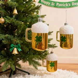 Detail shot of St. Patrick's Day beer mug ornaments with shamrocks hanging on a tree.