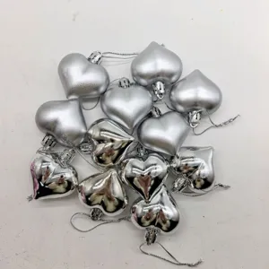 Set of 12 silver heart-shaped ornaments with both matte and shiny metallic finishes