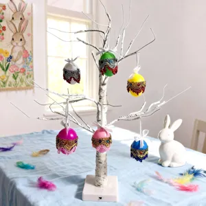 Close-up view of colorful Bohemian style sequined Easter hanging eggs on a decorative tree