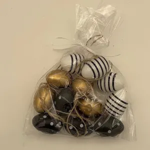 Set of decorative Easter eggs in a clear bag with hanging strings for home decor