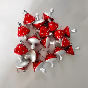 Collection of red painted mushroom ornaments with white dots for Christmas decoration.