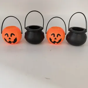Set of four Halloween pumpkin and black cauldron candy buckets for trick or treating