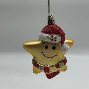 Detailed shot of a gold star Christmas ornament wearing a glittery red Santa hat.
