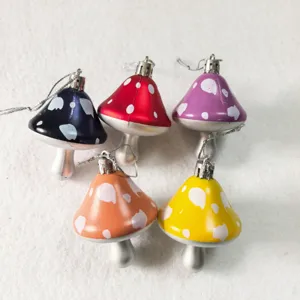 Detail of colorful painted plastic mushroom hanging ornaments for Christmas decor.