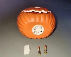 Detail of Halloween pumpkin light battery compartment with two AA batteries shown.