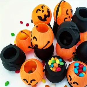 Detailed top view of festive orange pumpkin and black cauldron Halloween candy buckets.