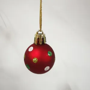 Macro view of 3cm mini red Christmas ball with glitter dots