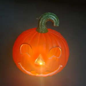 Glow-in-the-dark plastic Halloween pumpkin lantern with smiling face, battery-operated