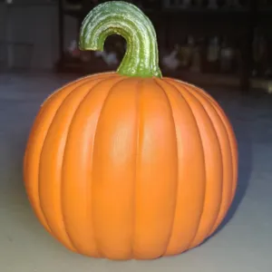 Close-up of a realistic textured orange plastic pumpkin lamp for Halloween decoration