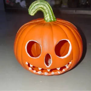 Classic Halloween orange plastic pumpkin lantern decoration with a carved smiling face.