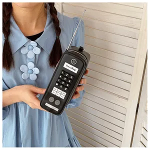 Detailed view of creative vintage brick cellphone shaped handbag in black leather