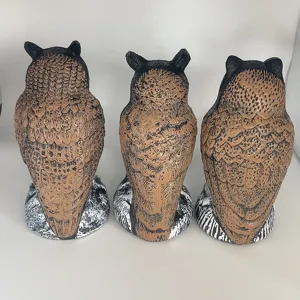 Back view showing texture of three plastic owl decoys for outdoor garden bird scaring